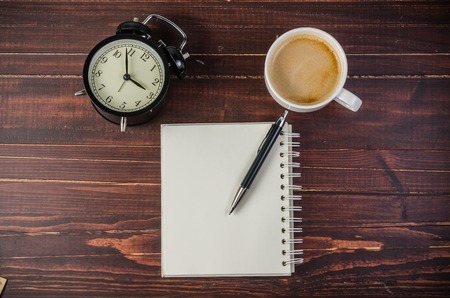 notebook with pencils and stationery on wooden table,coffee breakの写真素材