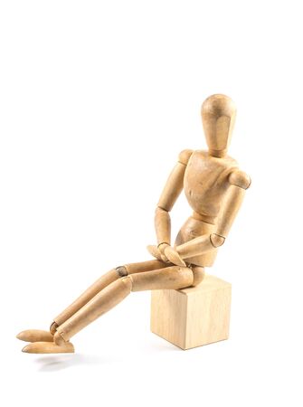 wooden figure sit on wooden cube の写真素材