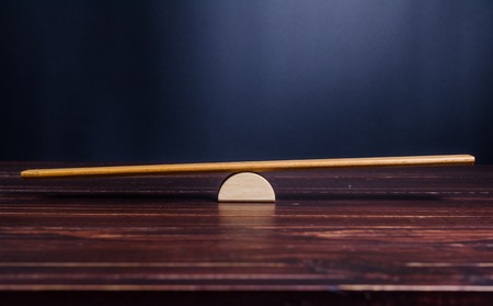 balance scale on wooden boardの写真素材