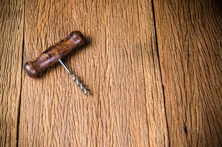 corkscrew for open wine cork on wooden backgroundの写真素材