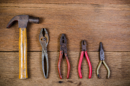 Old carpenter tools on wooden background,rust pliersの写真素材