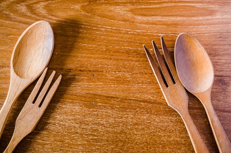 wooden spoon and fork on wooden board backgroundの写真素材