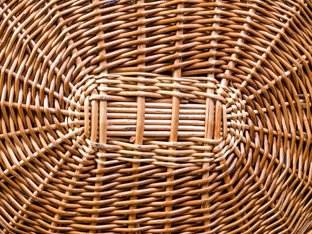 wicker basket on wooden board and black backgroundの写真素材