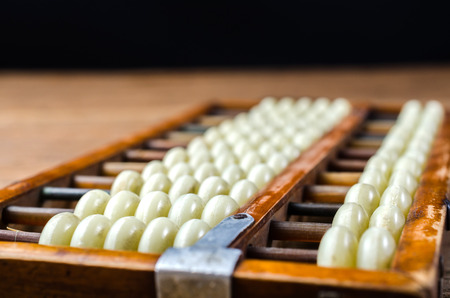 retro abacus isolated on wooden backgroundの写真素材