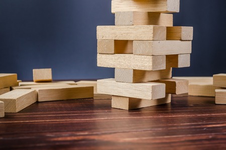 wooden block tower stack game on wooden board backgroundの写真素材