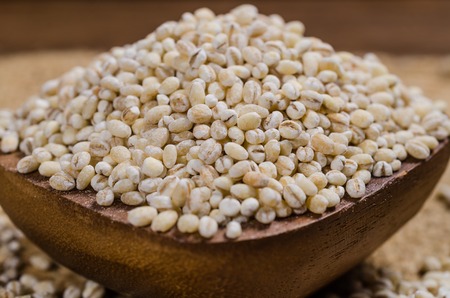 Barley grain in wooden bowl on sackcloth,Barley grain is raw material of bread, beer, whiskeys, vodkas,agriculture productの写真素材