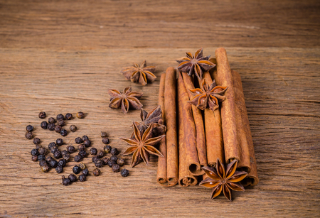 Star anise and cinnamon stick with black pepper on wooden board background,Chinese star aniseedの写真素材