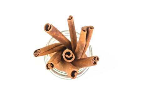 cinnamon sticks in glass isolated on white backgroundの写真素材
