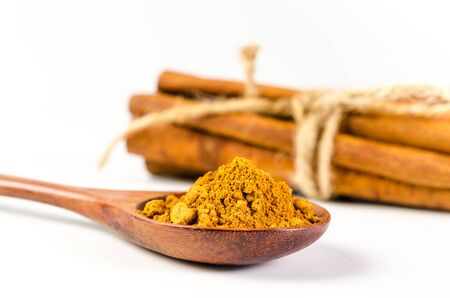 cinnamon powder and cinnamon sticks isolated on white backgroundの写真素材