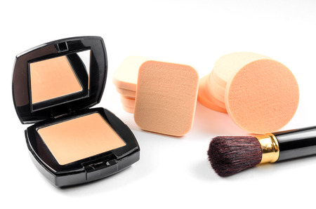 Face powder sponge with powder and brush on white backgroundの写真素材