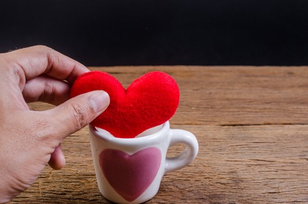 put heart in coffee cup on wooden board , valentine concept,の写真素材