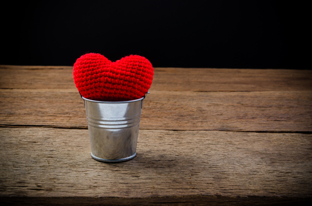 Red heart with tin can on wooden board , love valentine day conceptの写真素材