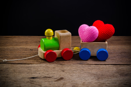 Wooden toy train with hearts on wooden board , valentine conceptの写真素材