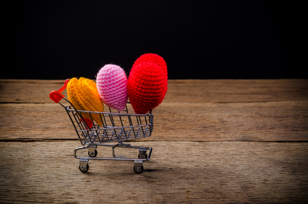 hearts in shopping cart on wooden board , love valentine day conceptの写真素材