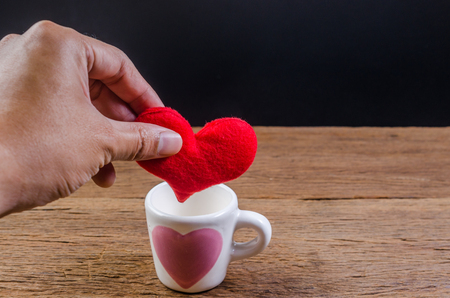 put heart in coffee cup on wooden board , valentine concept,の写真素材