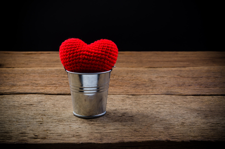 Red heart with tin can on wooden board , love valentine day conceptの写真素材