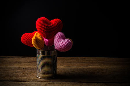 hearts with tin can on wooden board , love valentine day conceptの写真素材