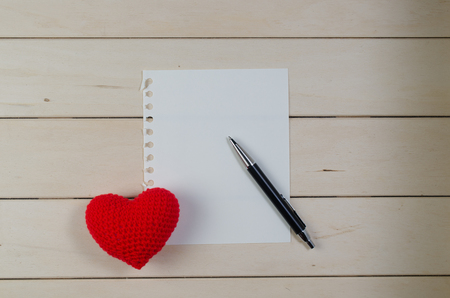 heart shape with blank paper on wooden board , love valentine day conceptの写真素材