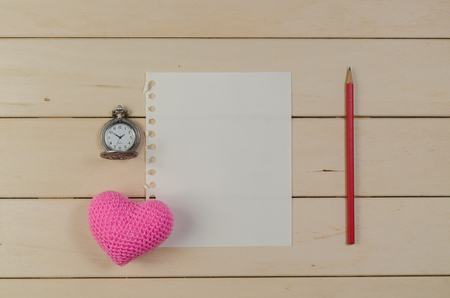 heart shape with blank paper and pocket watch on wooden board , love valentine day conceptの写真素材