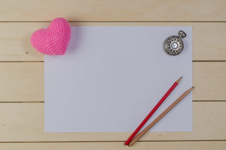 heart shape with blank paper and pocket watch on wooden board , love valentine day conceptの写真素材