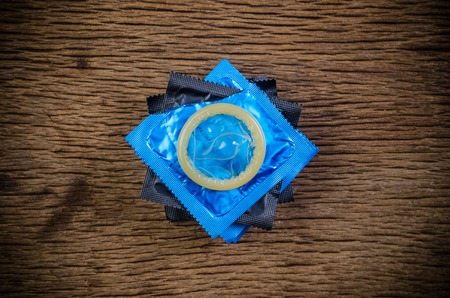 stack condoms on wooden tableの写真素材