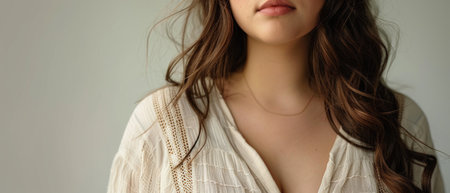Close-up portrait of beautiful young woman in white blouse.の素材