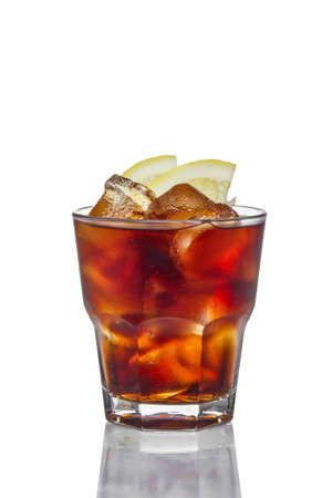 Alcoholic cocktail in rocks glass - Cuba Libre made of cola, lemon and rum. Isolated on white backgroundの写真素材