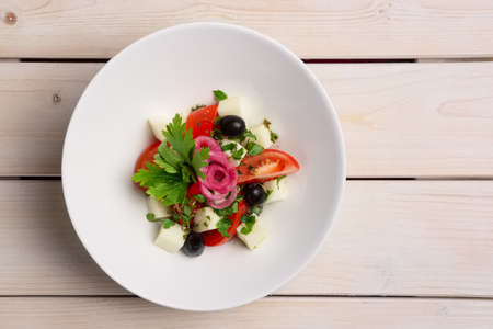 Salad with mozzarella, tomato and olives. Top view.の写真素材