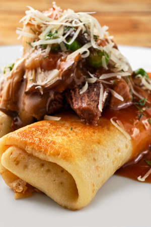 Macro photo of thin pancakes stuffed with beef and mushroomsの写真素材