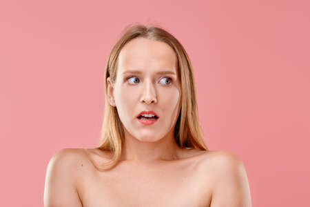 Scared young woman looking awayの写真素材