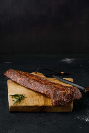 Smoked beef striploin meat on cutting boardの写真素材