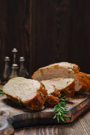 Closeup view of pork collar joint baked in oven on wooden cutting boardの写真素材