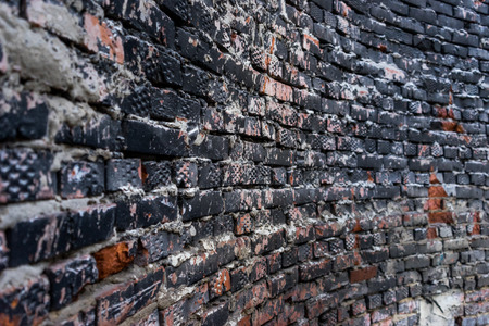 Grunge curved brick weathered wall of black, gray and brown colorsの写真素材