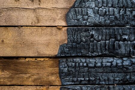 Half charred wooden wall of the house, contrastの写真素材