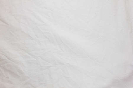 Closeup crumpled white fabric texture for backgroundの写真素材