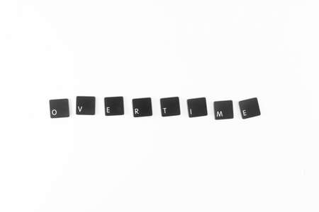 Overtime word written with black computer keyboard keysの写真素材