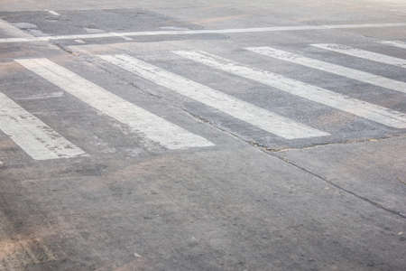 crosswalk on the bad  dirty asphalt roadの写真素材