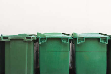 Green city trash cans on white wallの写真素材