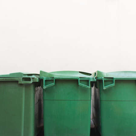 Green city trash cans on white wallの写真素材