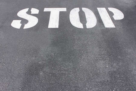 Word stop written on asphalt road textureの写真素材