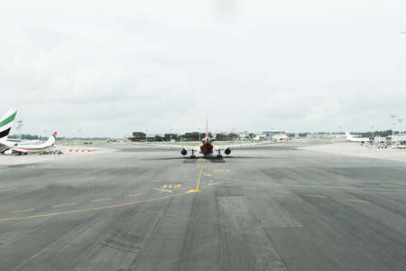 back of passenger plane on runway at airportの写真素材