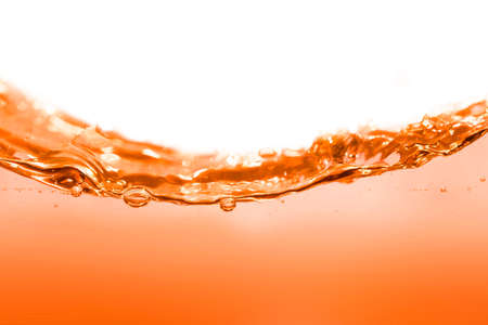 Clean orange water with water droplets and wavesの写真素材
