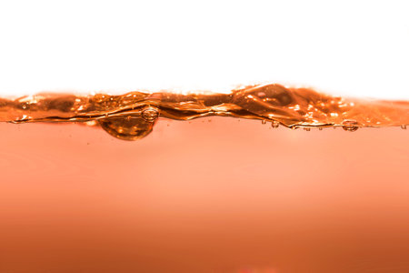 orange clean water with water drops and wavesの写真素材