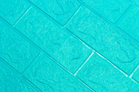 The blue wallpaper texture has an abstract roughness and brick wall pattern for the background.の写真素材