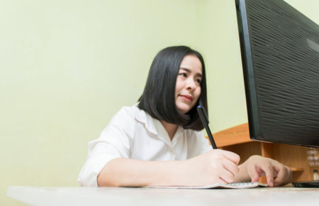Blurred image Asian woman searching for information about work on computer concept work from homeの写真素材