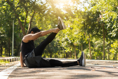 man sitting warm up in the park to exercise health