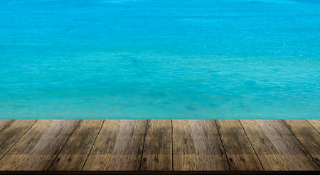 Beautiful wooden floor and blue background, sea water and sky.