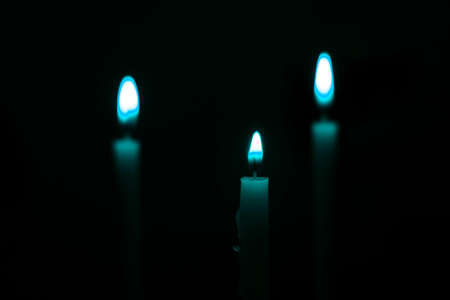 candles that are lit in the darkの写真素材