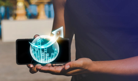 Hologram trade with your tablet or smartphone to earn and money Analyze the marketing from business stats charts and graphs.の写真素材