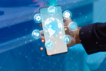 Smartphone in hand and business icons on the screen. Business concept.